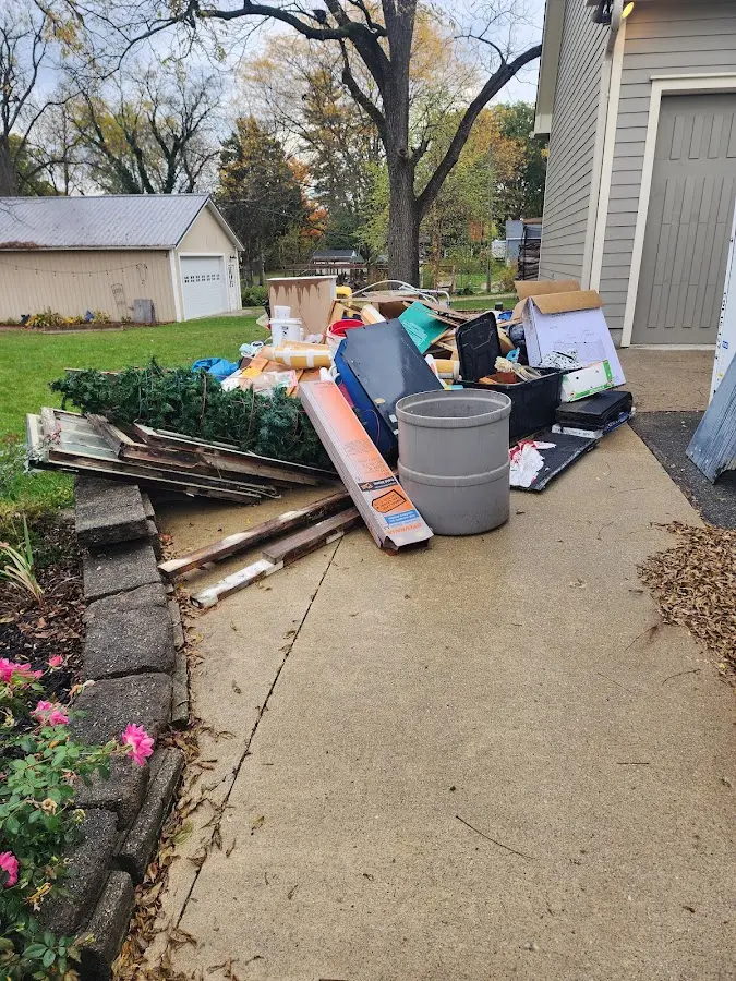 Dumpster being loaded with debris for 3 Yard Dumpster Rental in Scott AFB
